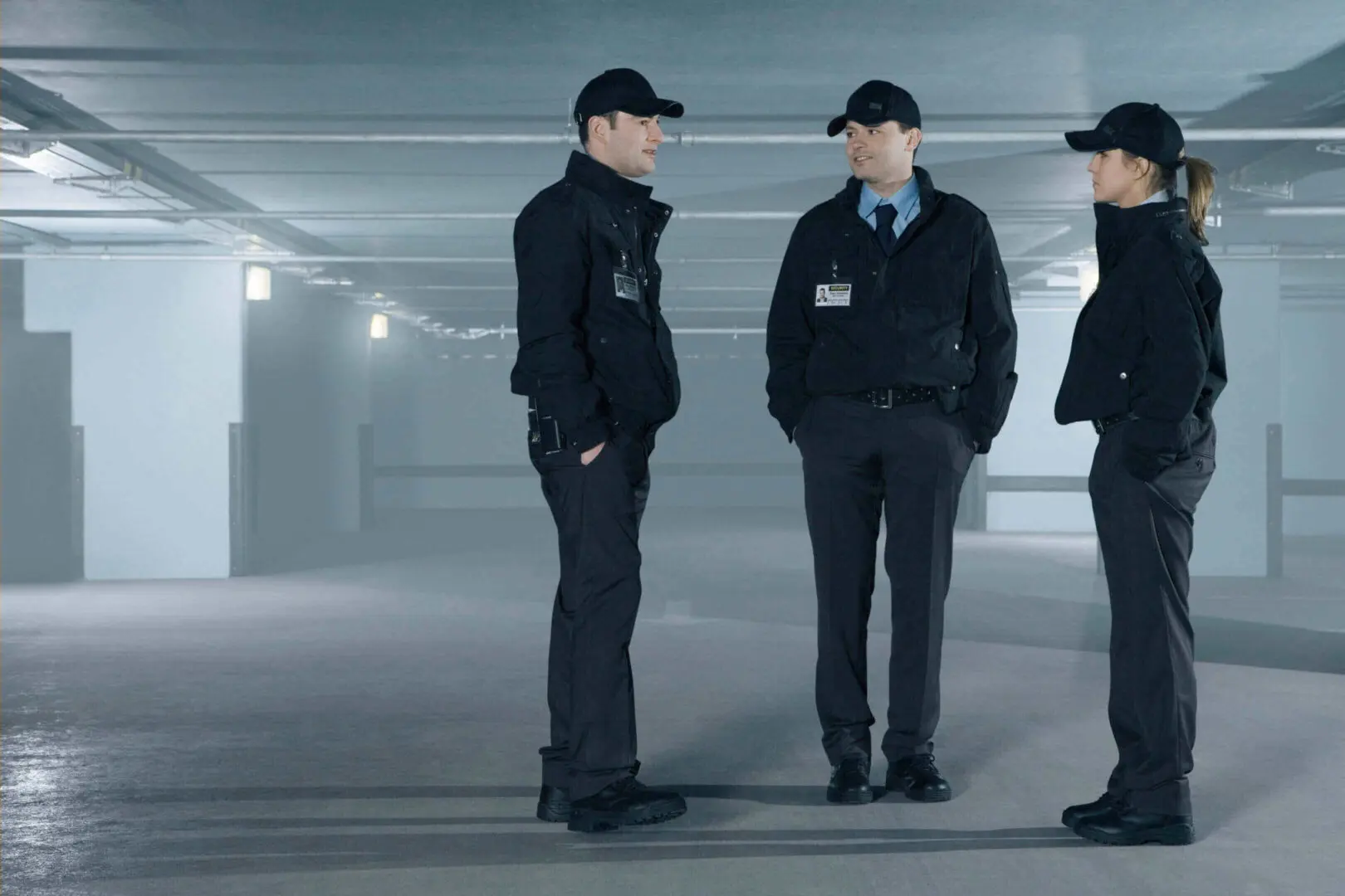 Security team discussing in a parking garage.